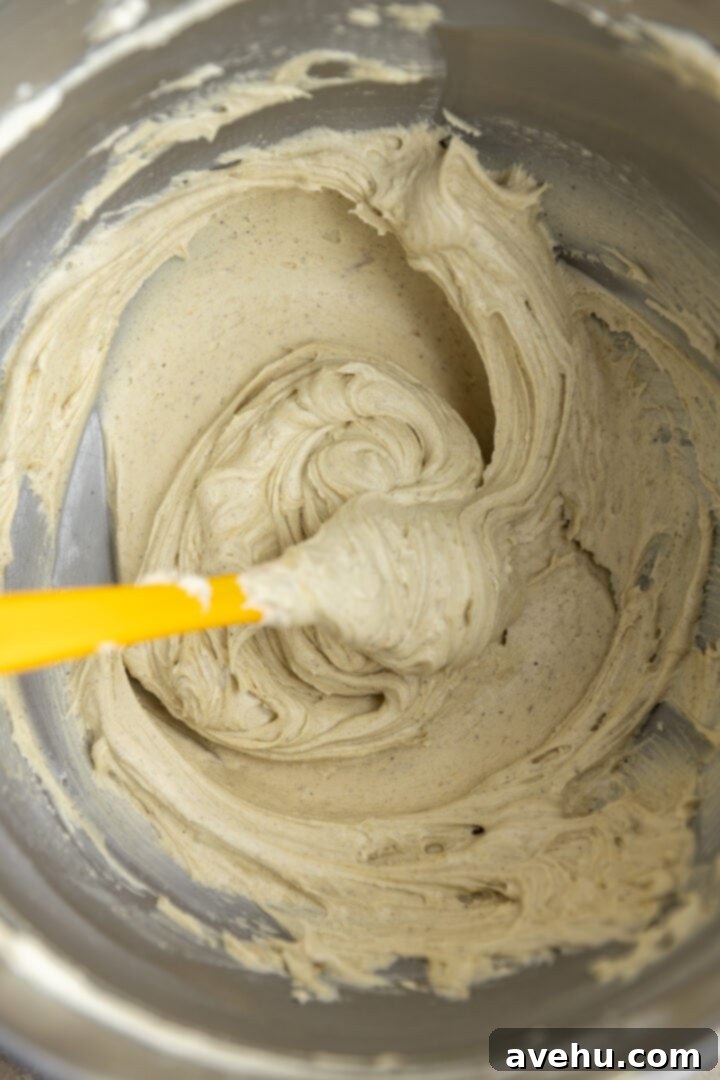Effortless 5 Minute Pistachio Frosting 6 Pistachio icing in a mixing bowl with a spatula.
