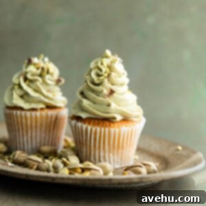 Effortless 5 Minute Pistachio Frosting 8 Cupcakes topped with pistachio frosting.