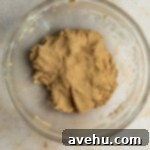 Easy 20 Minute Chip Free Chocolate Cookies 4 Cookie dough without chocolate chips in a glass bowl.