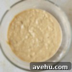 25 Minute Dreamy Mini Banana Bites 4 Banana muffin batter in a glass bowl.