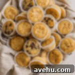 25 Minute Dreamy Mini Banana Bites 6 Mini banana muffins in a bowl lined with a linen napkin.