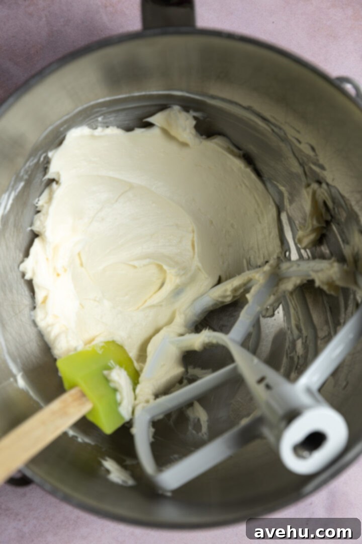 Orange Zest Cream Cheese Cloud 5 Cream cheese and butter mixed in a mixing bowl.