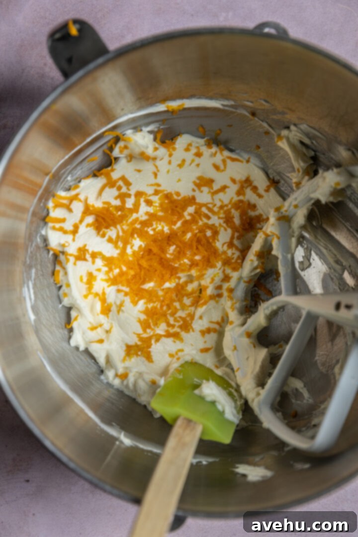 Orange Zest Cream Cheese Cloud 6 Orange zest and juice added to a bowl.