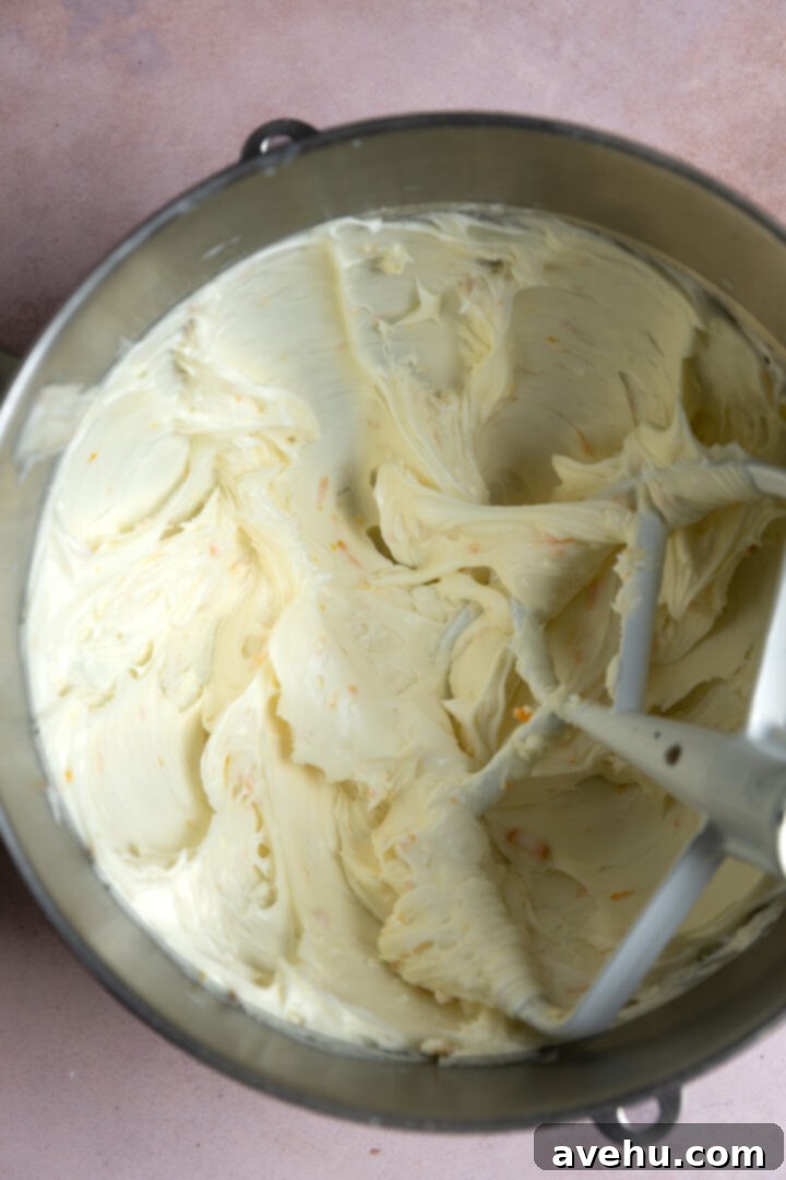Orange Zest Cream Cheese Cloud 8 Frosting being made in a mixing bowl.