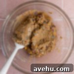 Birthday cake cookie batter in a glass bowl.