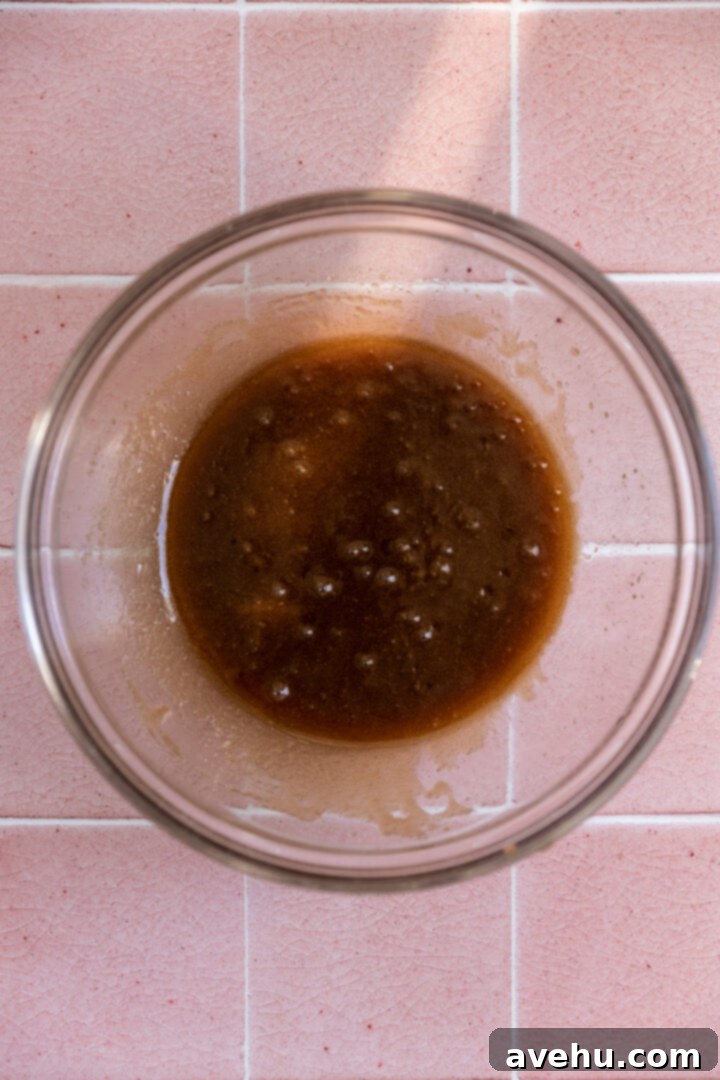 Quick 30 Minute Birthday Cake Cookies 3 Melted butter and sugar in a glass bowl, ready for mixing.