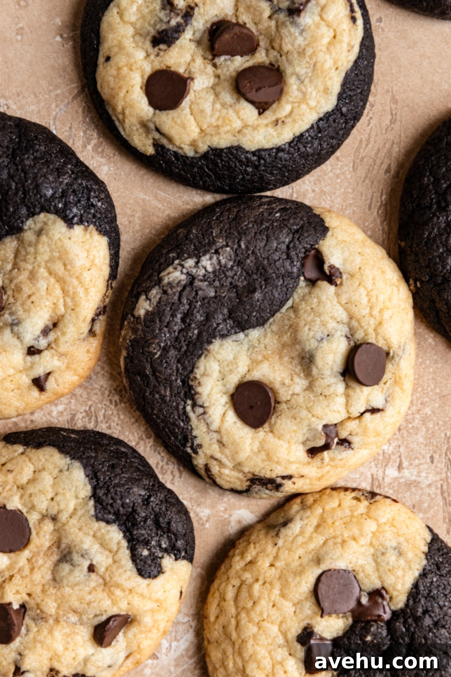 A perfectly baked brookies cookie, half rich brownie, half classic chocolate chip, resting on a rustic beige background. 