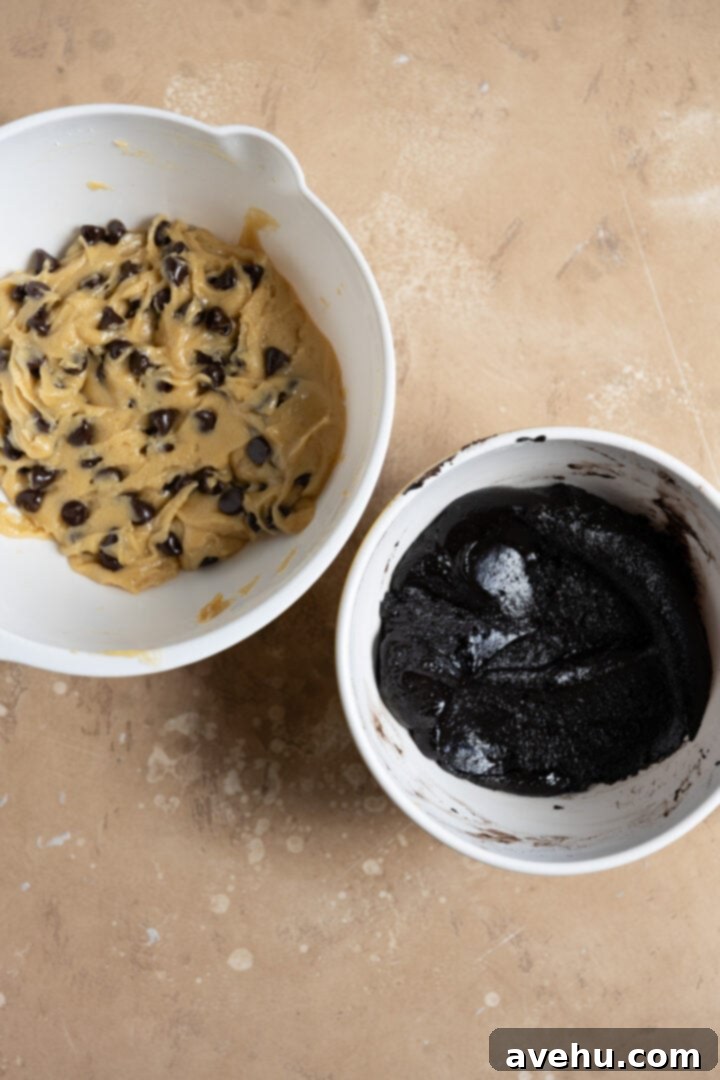 Two separate bowls showcasing the distinct batters: one a light chocolate chip cookie dough, the other a rich, dark brownie batter, ready for combining.