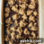 Effortless Chewy Brookie Bliss 6 Cookie dough dolloped over brownie batter in a 9x13" pan, ready for baking.