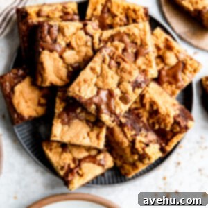Effortless Chewy Brookie Bliss 2 A plate of perfectly baked brookies, showcasing both the fudgy brownie and chewy cookie layers, stacked attractively.