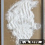 Silky Smooth Cookie Dough Frosting 11 flour spread on a parchment lined baking tray.