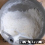 Silky Smooth Cookie Dough Frosting 13 Butter, heat treated flour, and powdered sugar mixed together in a mixing bowl.