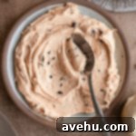 Silky Smooth Cookie Dough Frosting 15 A plate of cookie dough frosting smeared with a spoon.