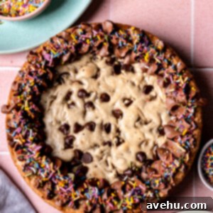 Whip Up 5-Minute Vegan Chocolate Frosting 2 A chocolate chip cookie cake topped with vegan chocolate frosting, showcasing the smooth texture and rich color.