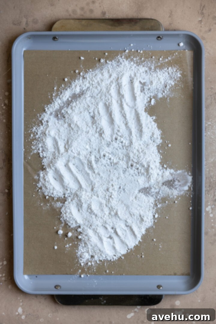 Easy Surprise Cookie Dough Cupcakes 3 All purpose flour spread all over a baking sheet lined with parchment paper.