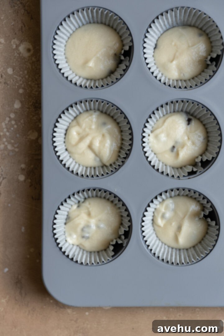 Easy Surprise Cookie Dough Cupcakes 8 Halfway filled cupcake liners with batter.