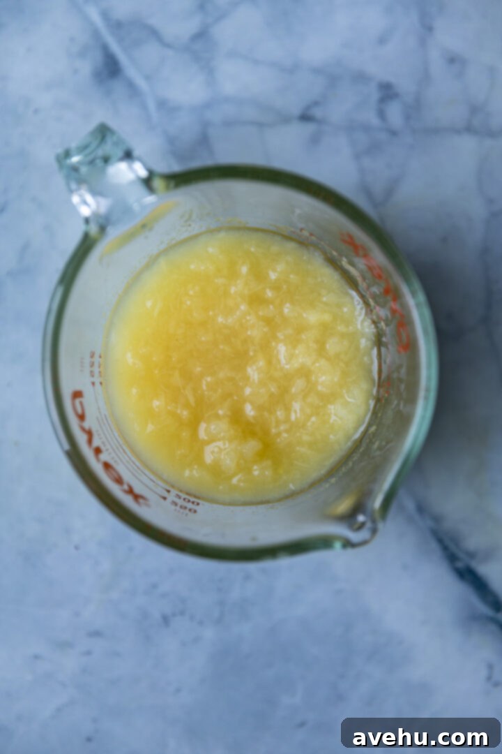 Effortlessly Moist Pineapple Cupcakes 6 Crushed pineapple with its juice in a measuring cup.