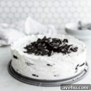 No-Bake 4-Ingredient Chocolate Dream 11 An icebox cake with crushed Oreos on top on a white surface.