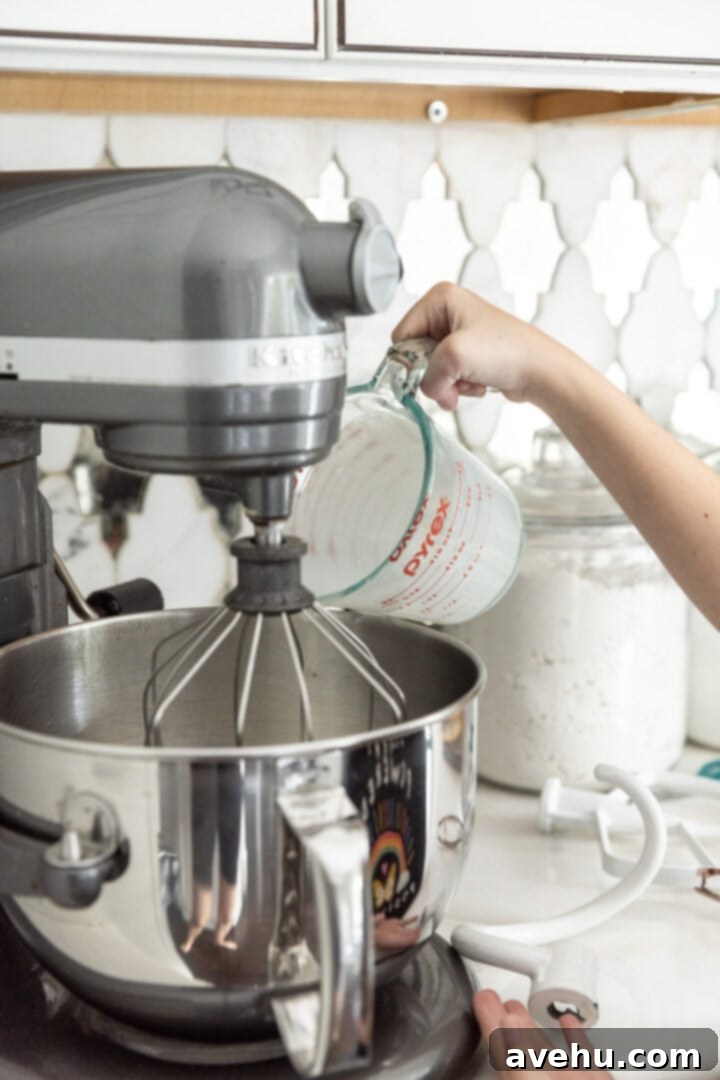 No-Bake 4-Ingredient Chocolate Dream 4 Heavy cream being poured into a stand mixer with a whip attachment.