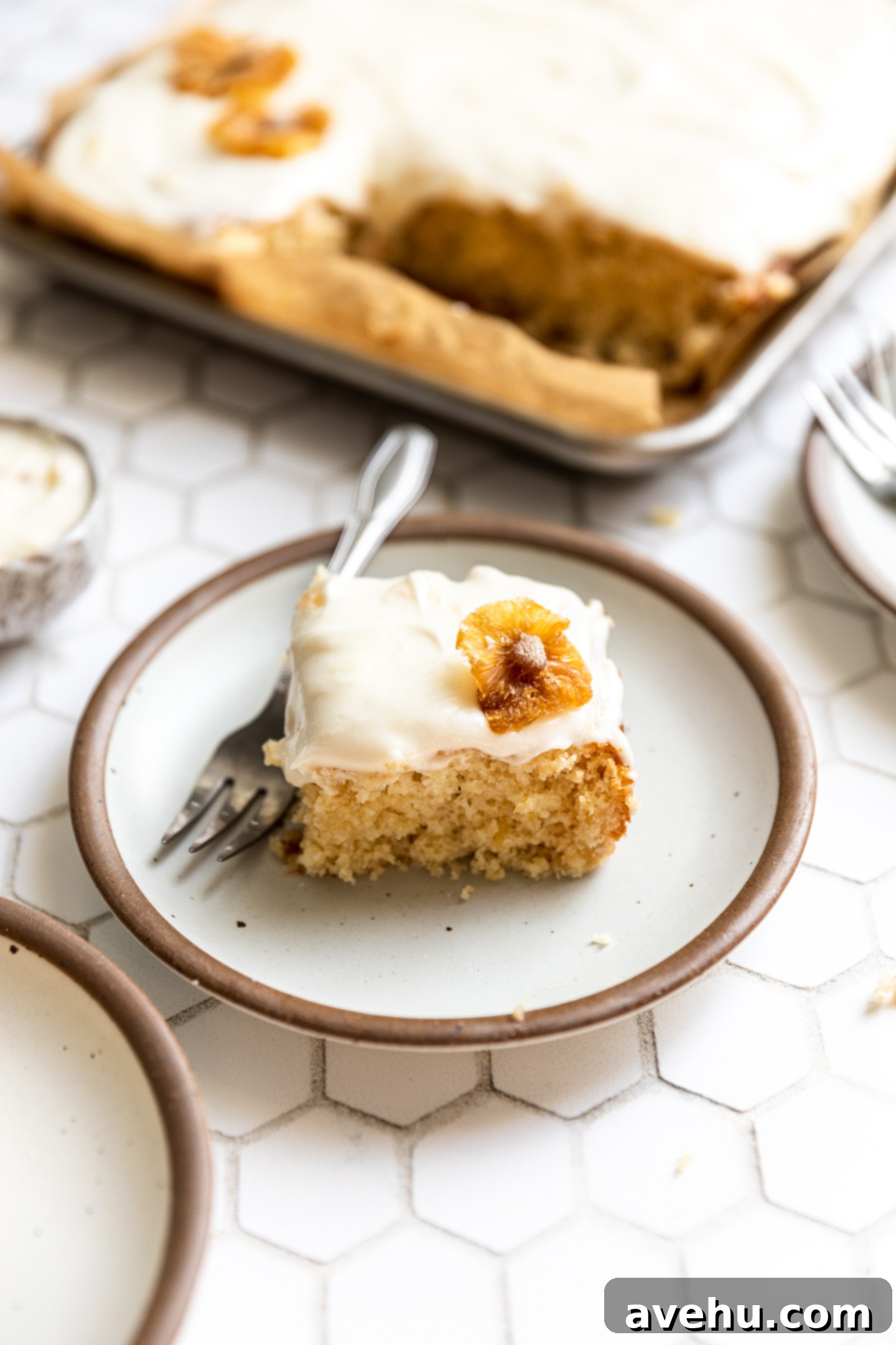 A beautifully frosted pineapple cake, garnished with dried pineapple slices.
