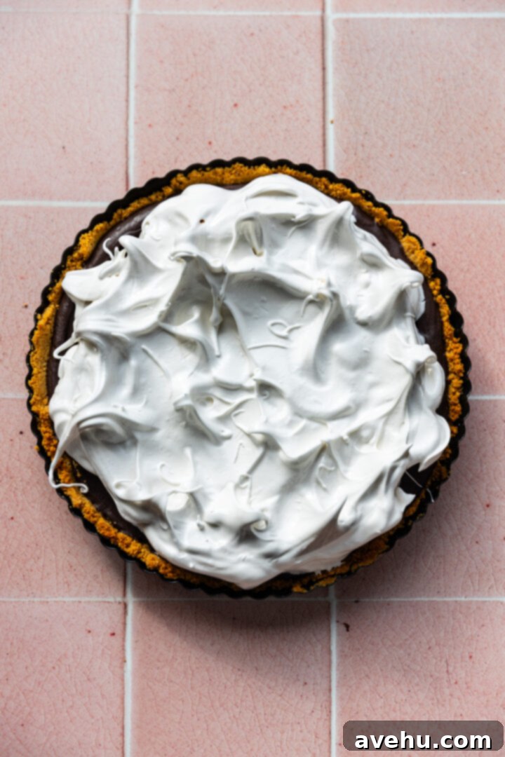 Foolproof S'mores Pie with Decadent Chocolate 11 A s'mores pie topped with meringue before its toasted.