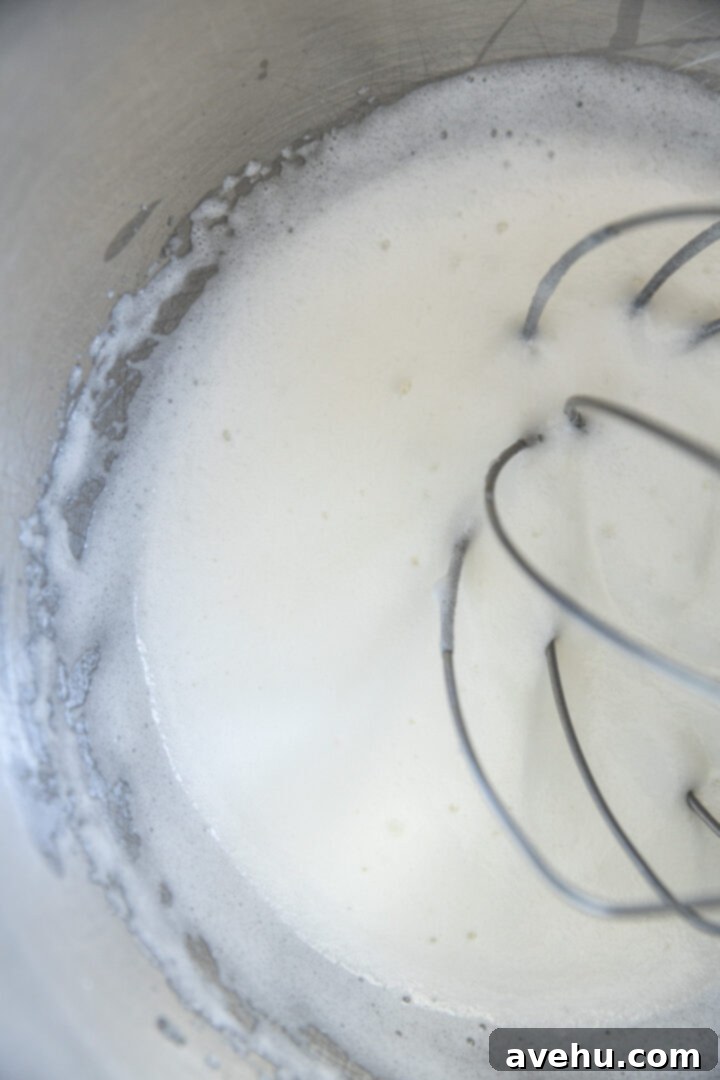 Foolproof S'mores Pie with Decadent Chocolate 9 Foamy egg whites in a mixing bowl.