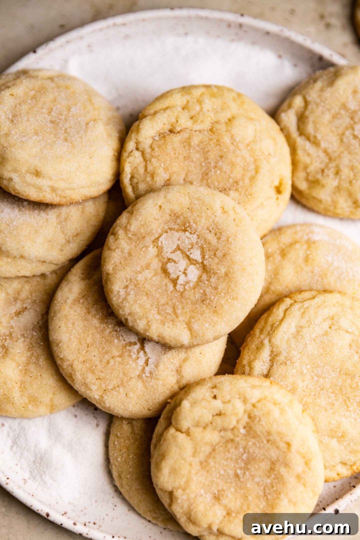 20-Minute Mixer-Free Sugar Cookies 2 Stack of soft and chewy sugar cookies on a plate, lightly sprinkled with sugar.