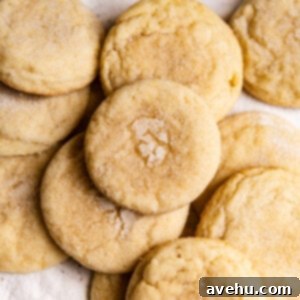 20-Minute Mixer-Free Sugar Cookies 11 Sugar cookies on top of each other on a plate, ready to be eaten.