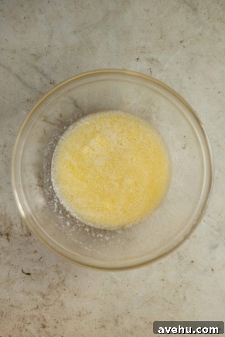 20-Minute Mixer-Free Sugar Cookies 3 Melted butter in a clear glass bowl, glistening and fully liquid.