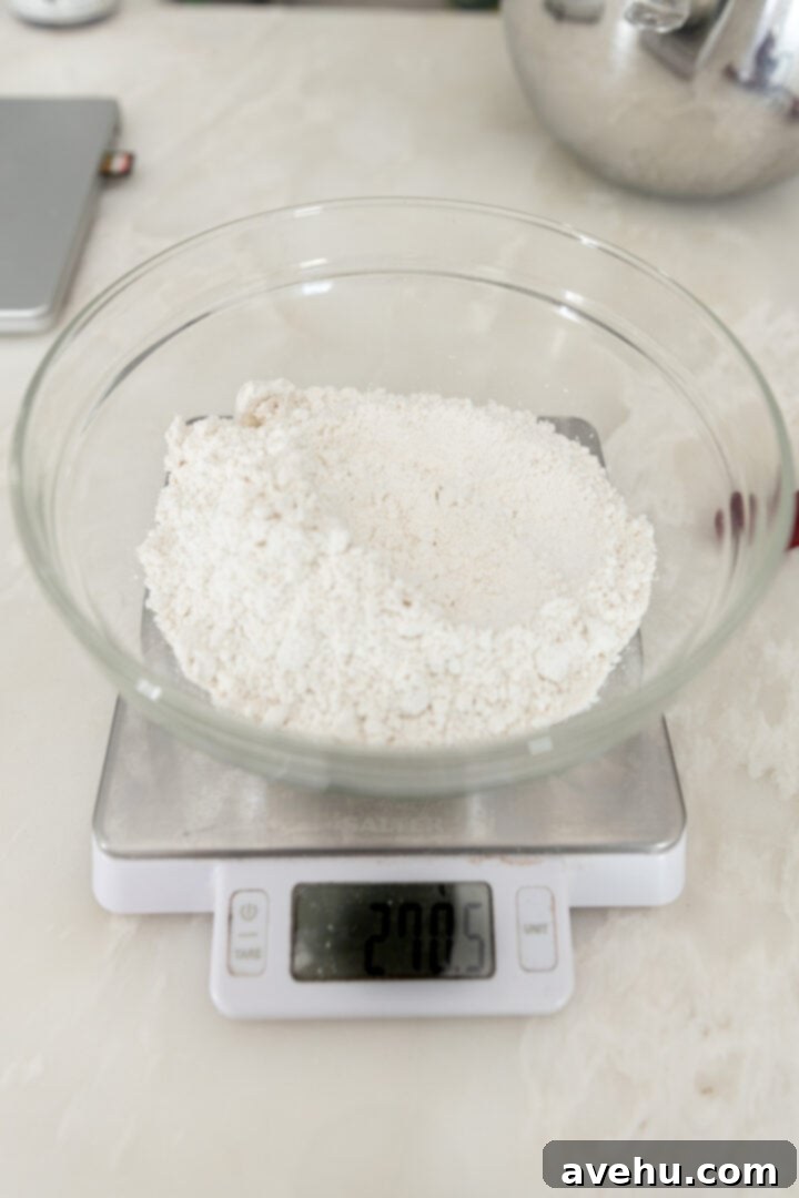 20-Minute Mixer-Free Sugar Cookies 5 Dry ingredients (flour, corn starch, baking soda, salt) in a glass bowl on a kitchen scale, ready to be added.