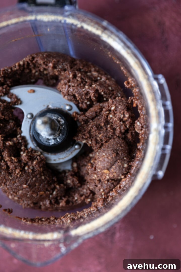 20-Minute Boozy Festive Rum Ball Recipe 8 Cohesive rum ball dough in a food processor, ready for shaping.