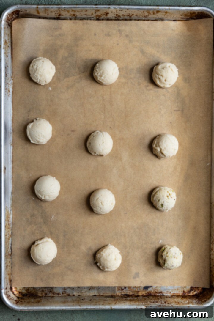 Effortless 3-Ingredient Snowball Cookies 9 Snowball cookie dough lined on a baking sheet.