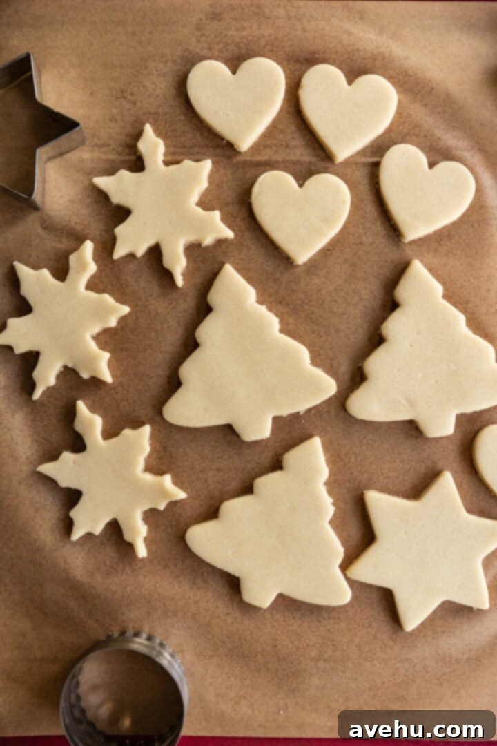 Instant Cut-Out Sugar Cookies 10 Baked snowflake and star-shaped cut-out sugar cookies on parchment paper, showing perfect edges.