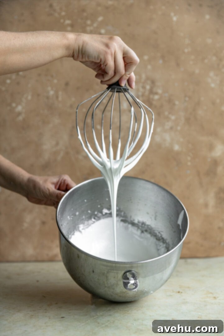 Quick Royal Icing Without Meringue Powder 6 A whip attachment lifted to show icing falling into the bow.