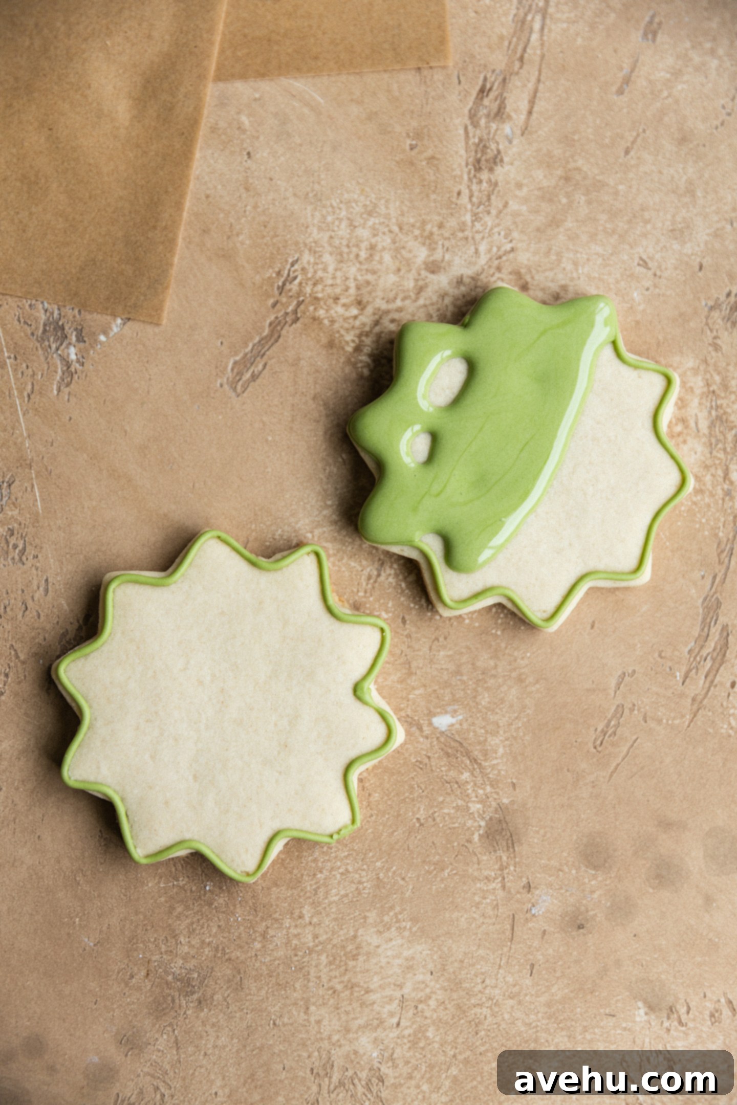 Quick Royal Icing Without Meringue Powder 8 2 cookies outlined with royal icing with one in the process of being flooded.