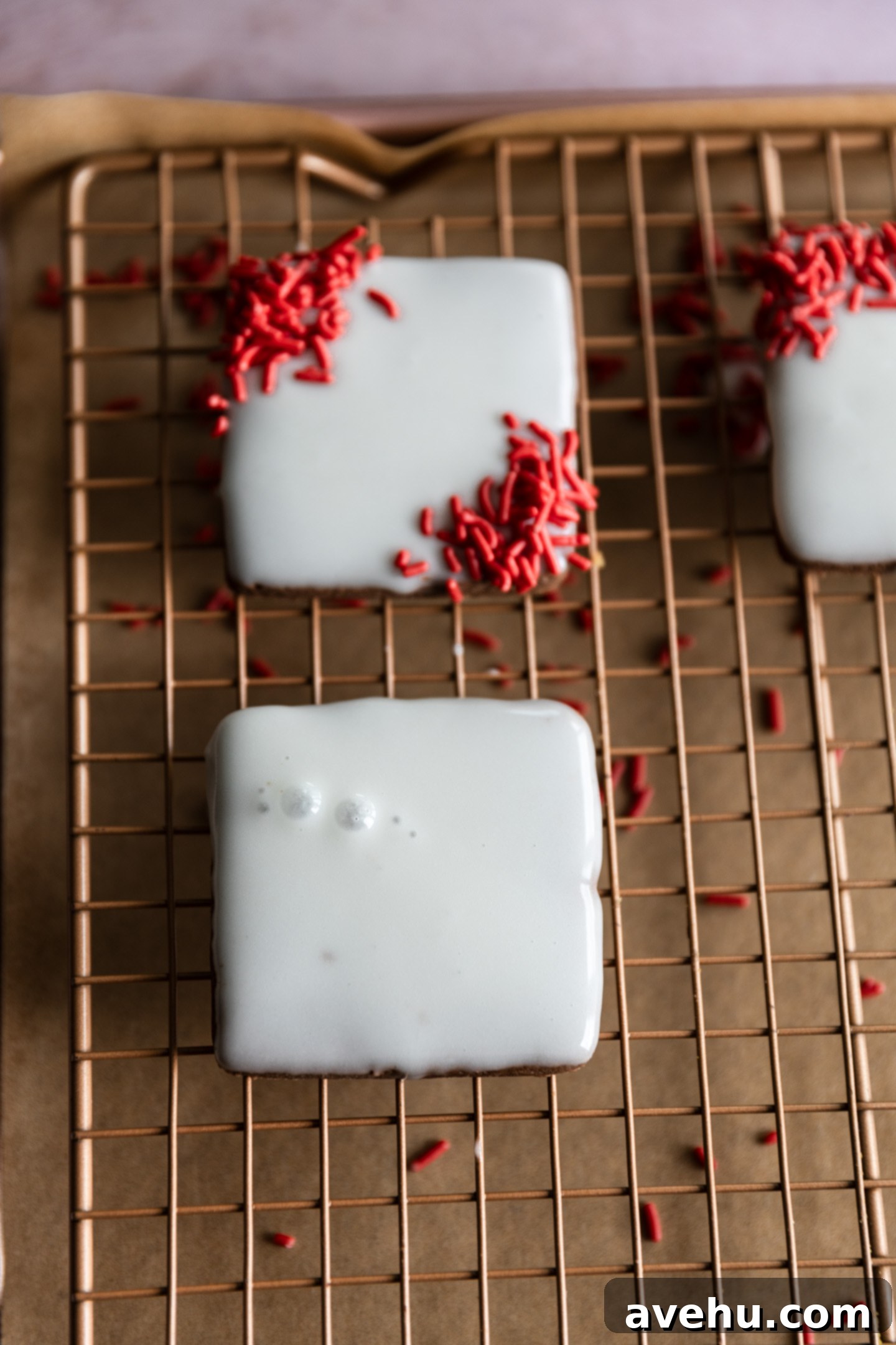 Quick No-Piping Cookie Icing 11 White iced cookies on a wire rack.