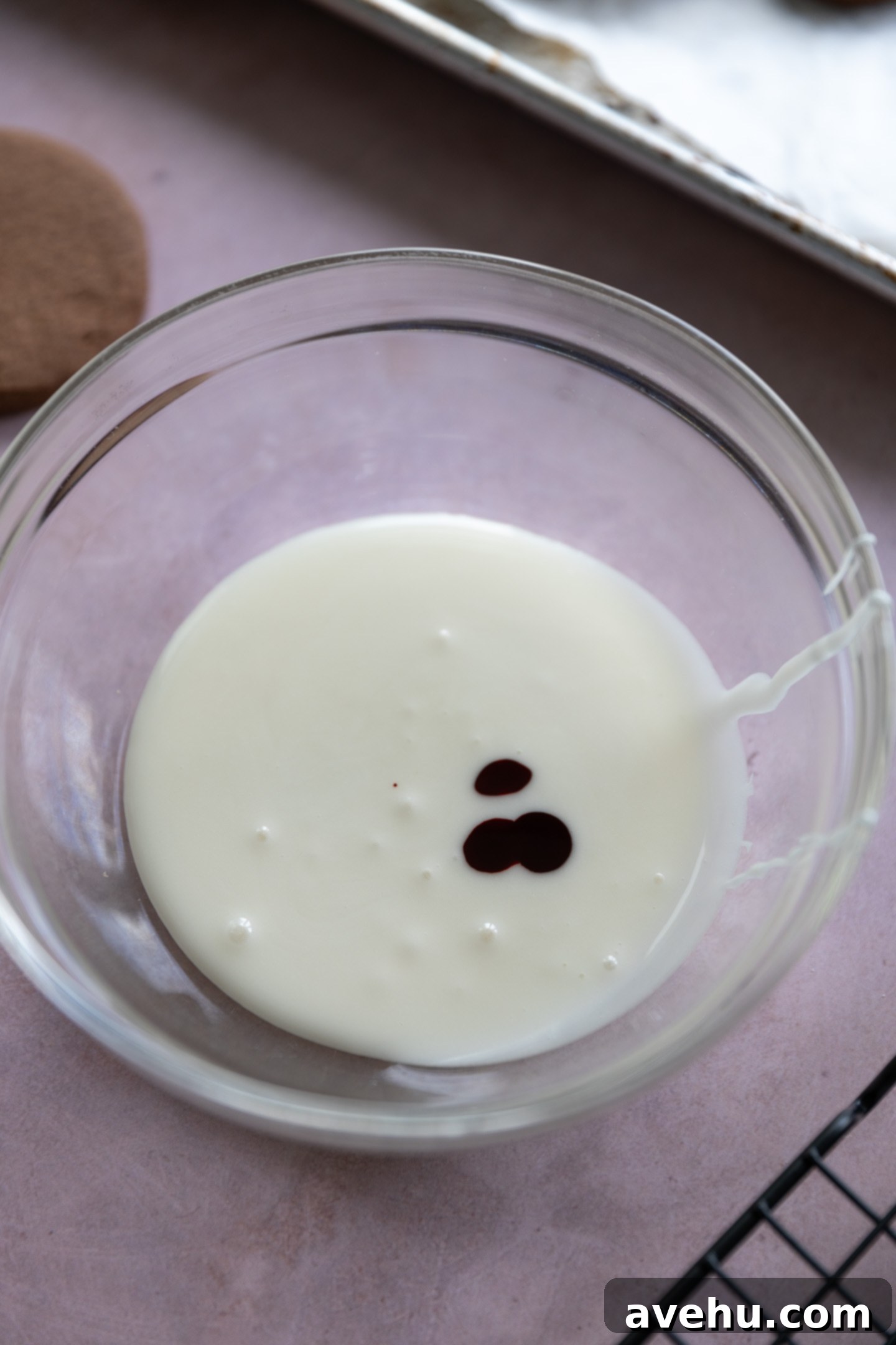 Quick No-Piping Cookie Icing 6 Food coloring drops in a bowl of white icing.