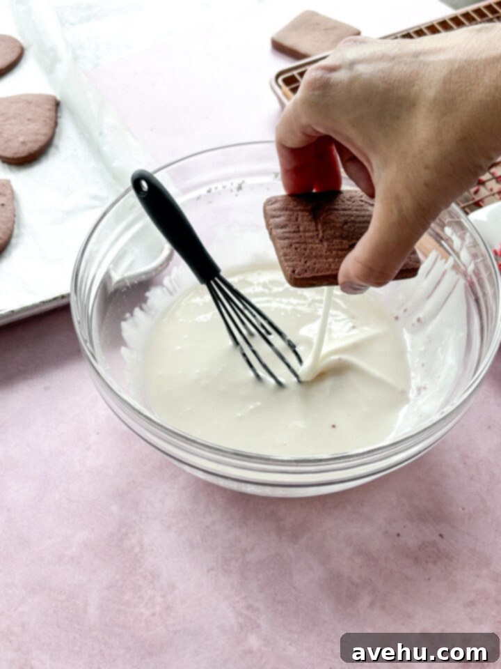 Quick No-Piping Cookie Icing 8 A cookie dripping icing into a bowl.