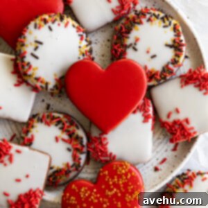 Instant Chocolate Sugar Cookie Delight 13 Close up of a stack of chocolate sugar cookies, some decorated, some plain, on a cookie sheet.