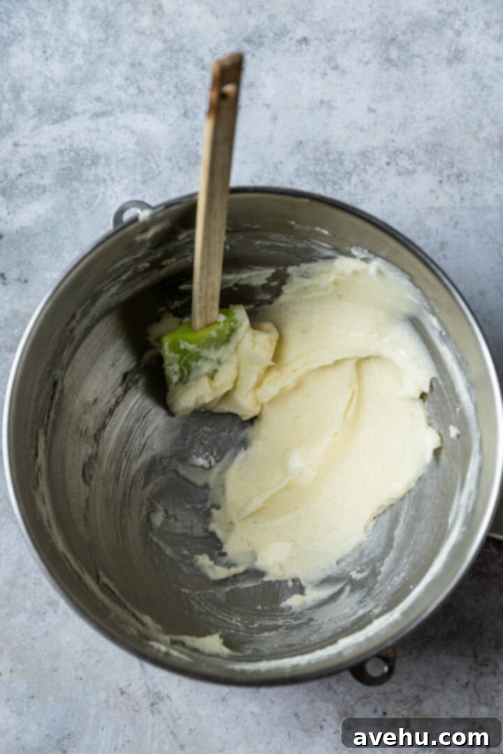 Instant Chocolate Sugar Cookie Delight 4 Creamed butter and sugar mixture in a mixing bowl with a spatula, showing its fluffy, pale texture after creaming.