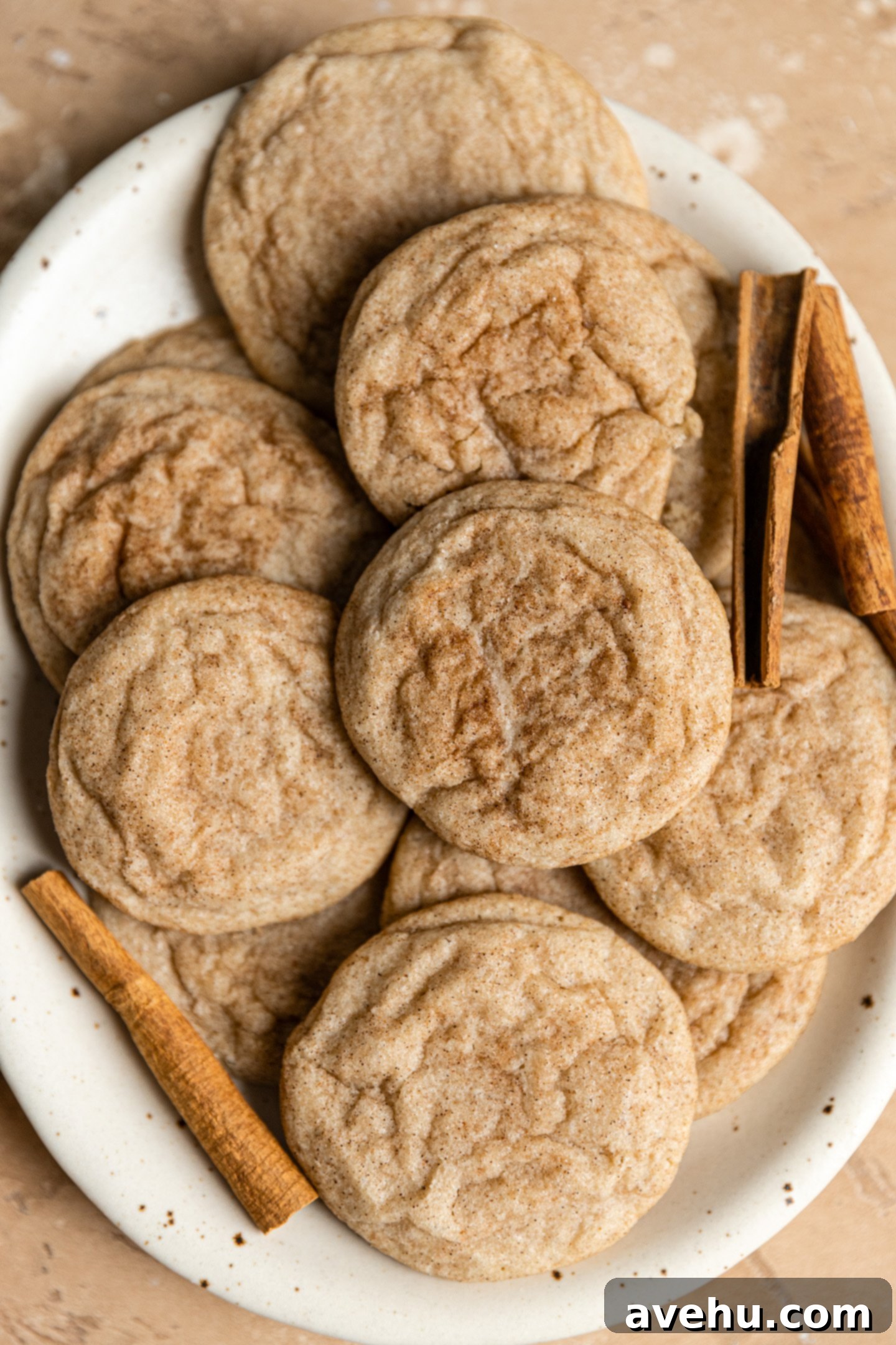 Cinnamon Sugar Chews in Minutes 2 A plate full of golden-brown cinnamon sugar cookies with crinkled tops, ready to be enjoyed.