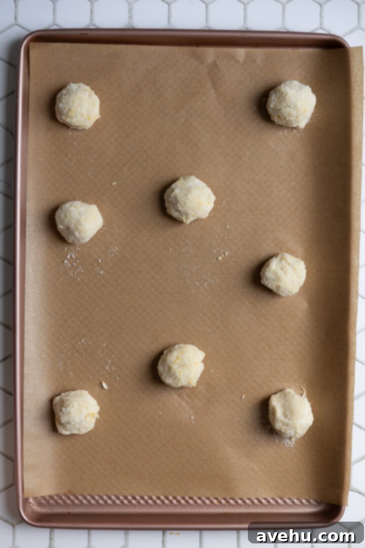 Zesty No-Chill Lemon Sugar Cookies 8 Six cookie dough balls on a lined cookie sheet.