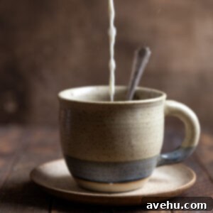 Instant Comfort Microwave Hot Cocoa for One 7 Hot milk being poured into a mug with chocolate and cocoa, ready to be stirred into delicious hot chocolate.