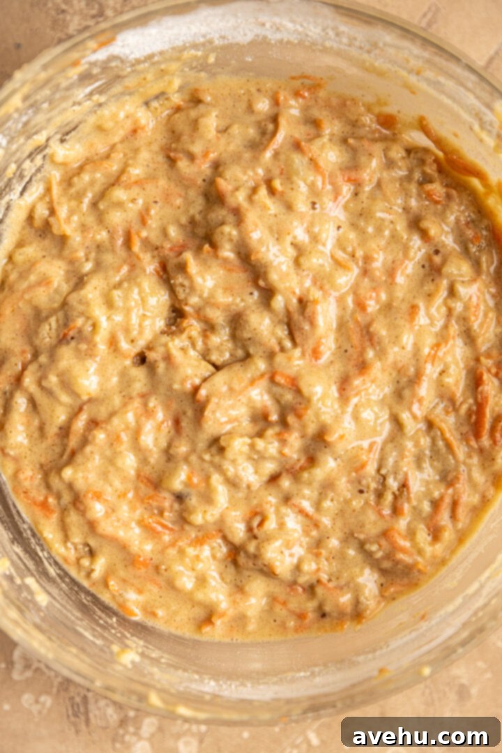 Kid-Approved Carrot Pineapple Muffins 6 Lumpy batter for carrot pineapple muffins, a key indicator of perfectly mixed muffin dough for a light and tender texture.