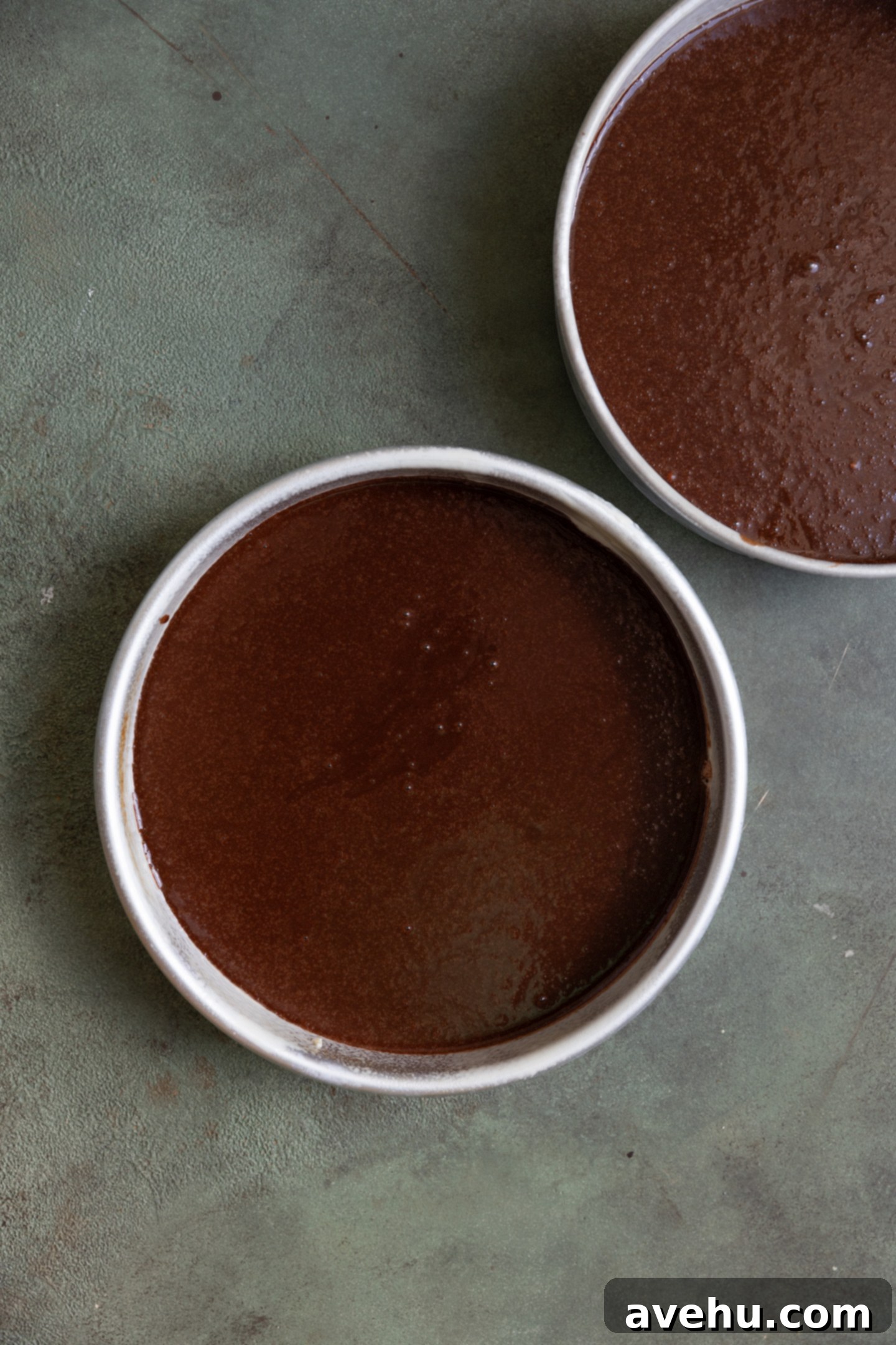 Guinness Kissed Chocolate Cake with Baileys Cloud 5 Smooth Guinness chocolate cake batter evenly divided into two 9-inch round baking tins, ready for the oven.