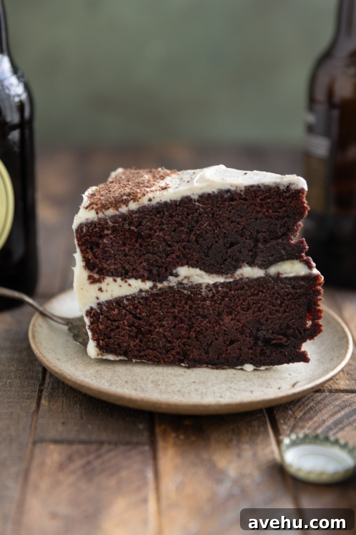 Guinness Kissed Chocolate Cake with Baileys Cloud 10 A perfect slice of moist Guinness chocolate cake with white Baileys frosting, served on a small plate.