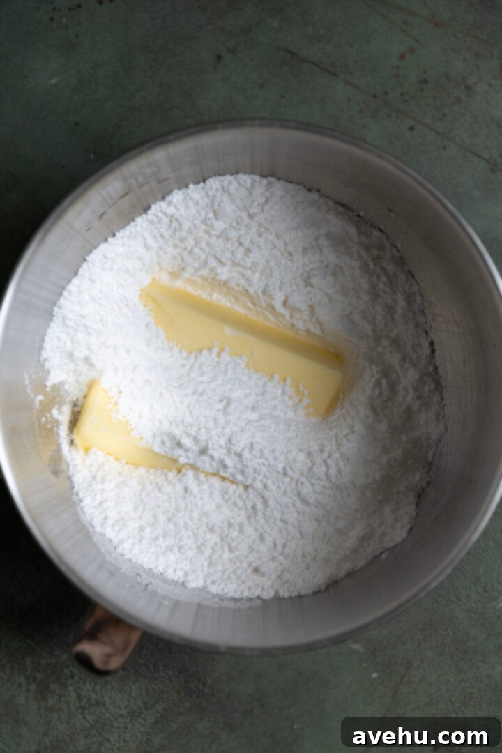 5 Minute Spiked Baileys Frosting 3 Softened butter and powdered sugar ready for mixing in a stand mixer bowl.