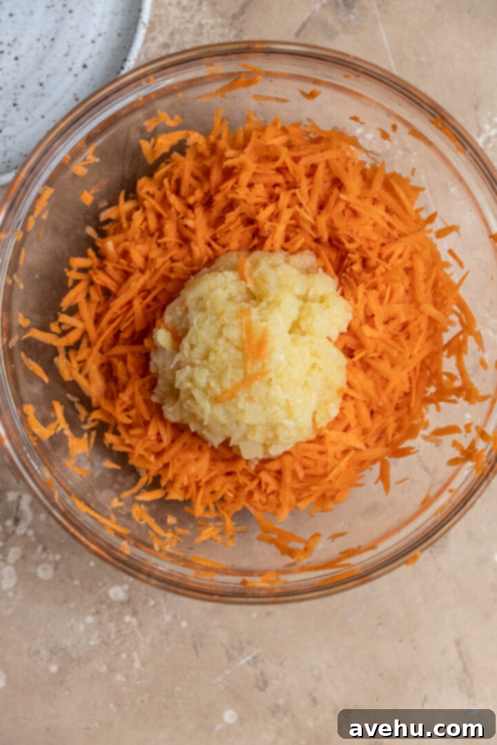 Sunshine Carrot Pineapple Sheet Cake 3 Hand shredded carrots in a bowl witch crushed pineapple.
