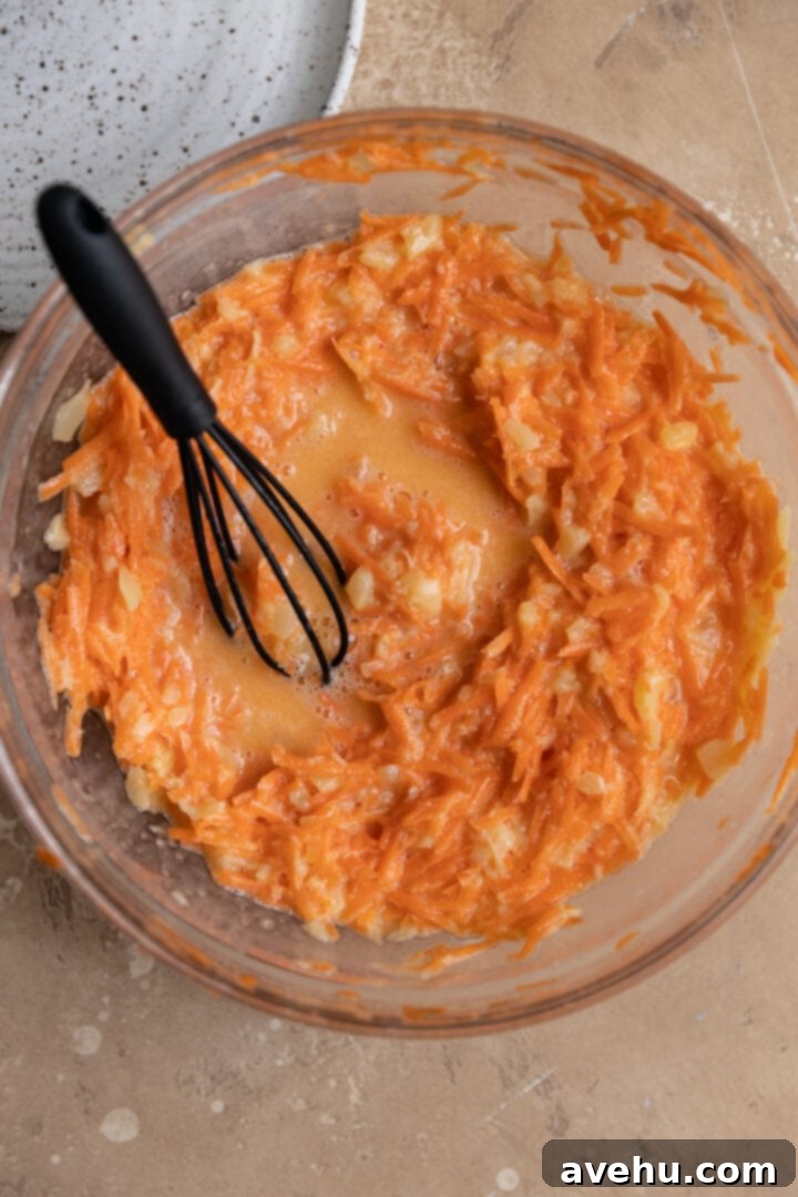 Sunshine Carrot Pineapple Sheet Cake 4 Wet ingredients for a carrot pineapple cake in a glass bowl.