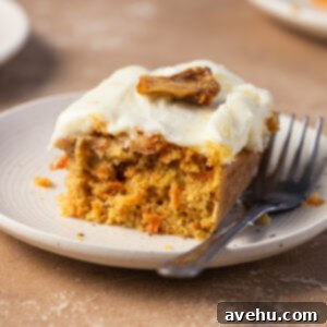 Sunshine Carrot Pineapple Sheet Cake 8 A piece of a carrot pineapple cake on a small plate next to a fork.